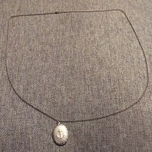 Silver anchor locket lightly worn